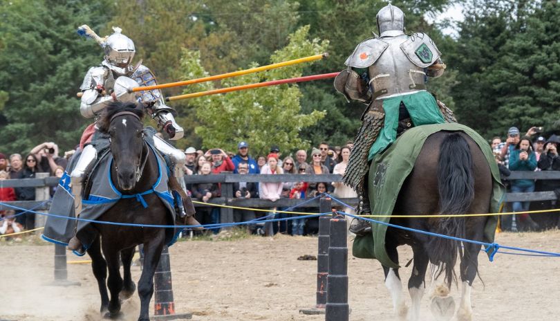 A scene from Oxford Renaissance Festival with two horse riders in armors. 